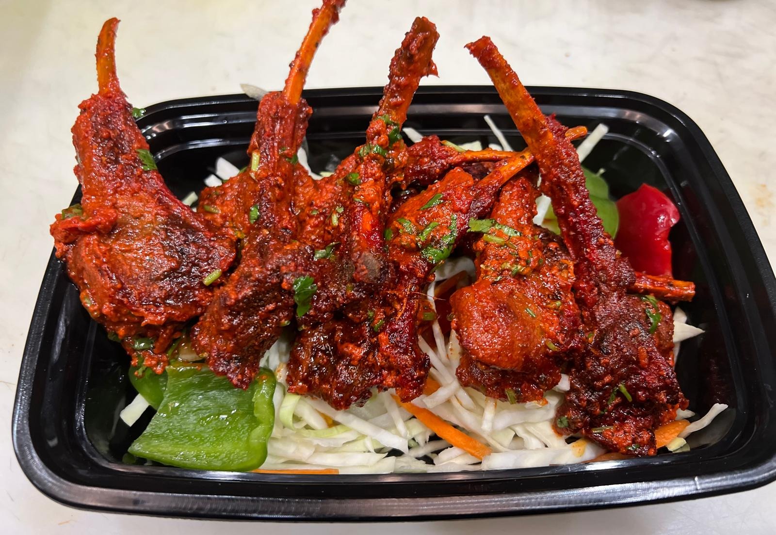 Manvirro's Tandoori Lamb Chops at Manvirros Indian Grill - Premium lamb chops marinated in traditional spices and tandoor-grilled