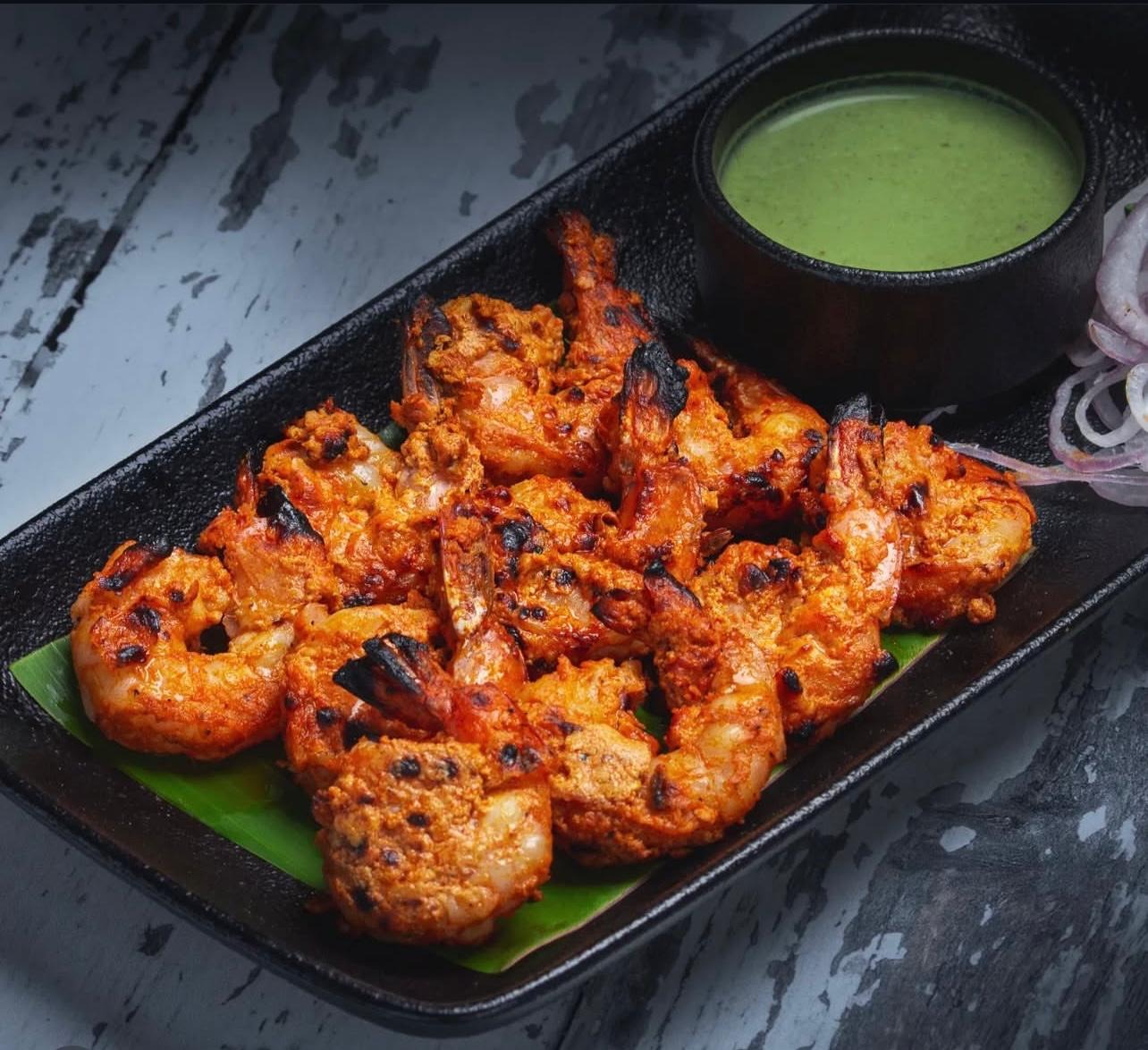 Tandoori Prawns at Manvirros Indian Grill - Succulent prawns marinated in tandoori spices and chargrilled