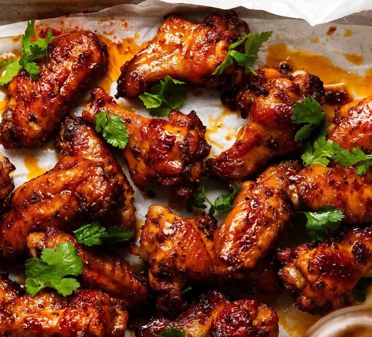 Manvirro's Tandoori Chicken Wings at Manvirros Indian Grill - Tender chicken wings marinated in authentic tandoori spices and grilled to perfection